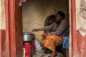 Therese Mukamana uses a biomass stove in Gyseny, Rwanda.